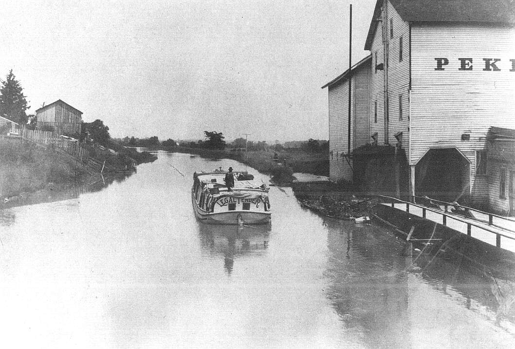 The packet boat Legal Tender on the Miami & Erie Canal at Waterville, about 1890. Two states nearly came to blows over where this canal would meet the lake; the railroads made it worthless within a dozen years of its opening, and it lingered on in decline, as here, for a generation more. Toledo Lucas County Public Library (public domain).